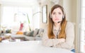 Beautiful young operator woman wearing headset at the office skeptic and nervous, disapproving expression on face with crossed Royalty Free Stock Photo