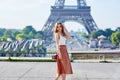 Beautiful young Parisian woman near the Eiffel tower Royalty Free Stock Photo