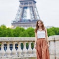 Beautiful young Parisian woman near the Eiffel tower Royalty Free Stock Photo