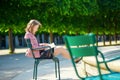 Beautiful young Parisian woman reading a book Royalty Free Stock Photo