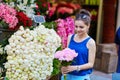 Beautiful young Parisian woman selecting peonies Royalty Free Stock Photo