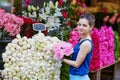 Beautiful young Parisian woman selecting pink peonies Royalty Free Stock Photo