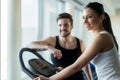 Beautiful, young people talking in a gym while working out Royalty Free Stock Photo