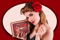 Beautiful young pin-up girl relishing on chocolate candy sweets.