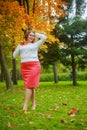 Plussize model in the autumn park