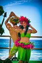 Beautiful young Polynesian woman and man performing traditional Hula dance