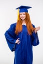 Beautiful young positive woman in graduation cap and gown Royalty Free Stock Photo