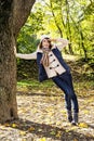 Beautiful young positive woman saluting under the beech tree in Royalty Free Stock Photo