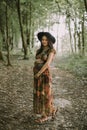 Beautiful young pregnant Caucasian woman, relaxing walking in the summer forest Royalty Free Stock Photo