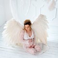 Beautiful young pregnant girl with big angel wings Royalty Free Stock Photo