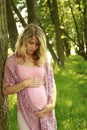 Beautiful young pregnant girl on nature