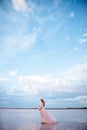 Beautiful young pregnant woman enjoying the sun on pink lake Royalty Free Stock Photo