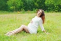 Beautiful young pregnant woman lying on grass Royalty Free Stock Photo