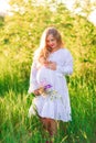 Beautiful young pregnant woman relaxing in nature on a beautiful sunny day Royalty Free Stock Photo