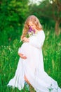 Beautiful young pregnant woman relaxing in nature on a beautiful sunny day Royalty Free Stock Photo