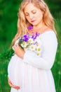 Beautiful young pregnant woman relaxing in nature on a beautiful sunny day Royalty Free Stock Photo