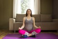 Beautiful young pregnant woman sitting in lotus position on yoga Royalty Free Stock Photo