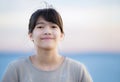 Beautiful young preteen girl enjoying outdoors by lake at sunset