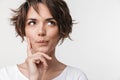 Beautiful young pretty thinking thoughtful woman posing isolated over white wall background Royalty Free Stock Photo