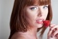 Beautiful young red hair woman with strawberries
