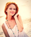 Beautiful young red-haired on the beach Royalty Free Stock Photo