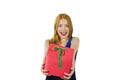 A beautiful young red-haired girl in an evening dress who holds a gift in a red box with both hands intending to present Royalty Free Stock Photo
