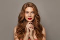 Beautiful young red-haired woman with long beauty curly hair on brown background Royalty Free Stock Photo