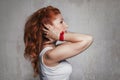 Beautiful young red-haired woman in a white T-shirt in profile Royalty Free Stock Photo