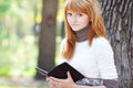 Beautiful young redhead teenager woman reading Royalty Free Stock Photo