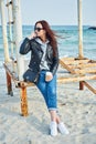 Beautiful young redhead woman sitting near the ocean Royalty Free Stock Photo