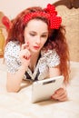 Beautiful young redhead woman reading with tablet