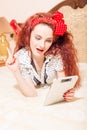 Beautiful young redhead woman reading with tablet