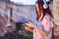 Cute Redhead Girl Enjoying Music in Ruins with Headset and Digital Tablet Royalty Free Stock Photo