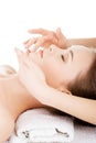 Beautiful young relaxed woman enjoy receiving face massage Royalty Free Stock Photo