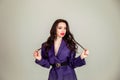 Beautiful young Russian model girl in retro clothes, she is dressed in a large male purple jacket Royalty Free Stock Photo