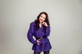 Beautiful young Russian model girl in retro clothes, she is dressed in a large male purple jacket Royalty Free Stock Photo