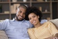 African couple in love relaxing on sofa look at camera Royalty Free Stock Photo