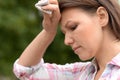 Portrait of beautiful young sad woman in park Royalty Free Stock Photo