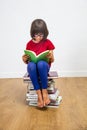 Beautiful young schoolgirl with eyeglasses reading for culture power, indoor
