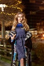 Beautiful young blonde wearing evening makeup in elegant fitting dress fashionable stylish expensive fur coat walk night stre Royalty Free Stock Photo