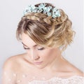 Beautiful young elegant sweet girl in the image of a bride with hair and flowers in her hair , delicate wedding makeup