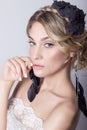 Beautiful young elegant sweet girl in the image of a bride with hair and flowers in her hair, delicate wedding makeup