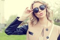 Beautiful young girl in sunglasses walking on a bright sunny summer day on city streets Royalty Free Stock Photo