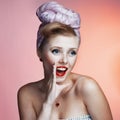 Beautiful young pin-up girl with surprised expression, on white background Royalty Free Stock Photo