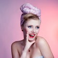 Beautiful young pin-up girl with surprised expression, on white background Royalty Free Stock Photo