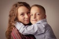 Beautiful young sister with her younger brother hugging each other as symbol of family, love and tenderness Royalty Free Stock Photo