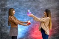 Beautiful young sisters. Christmas and New Year celebration. Two beautiful sisters exchanging with present boxes Royalty Free Stock Photo