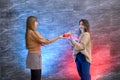 Beautiful young sisters. Christmas and New Year celebration. Two beautiful sisters exchanging with present boxes Royalty Free Stock Photo