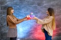 Beautiful young sisters. Christmas and New Year celebration. Two beautiful sisters exchanging with present boxes Royalty Free Stock Photo