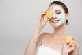 Beautiful young smile woman holding fresh lemon and orange slices. Skin care, spa, natural beauty and cosmetology concept Royalty Free Stock Photo